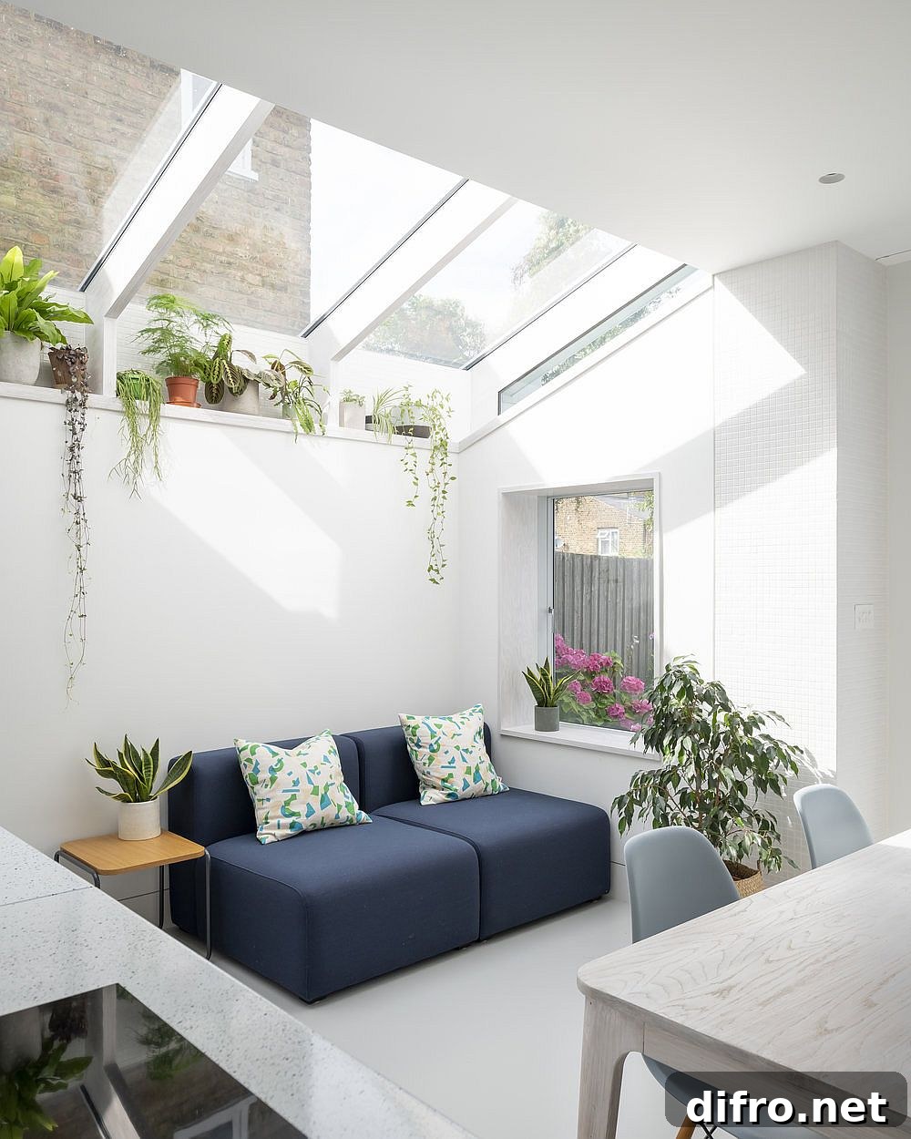 Glazed roof brings light into the new white extension to the classic Victorian terrace house