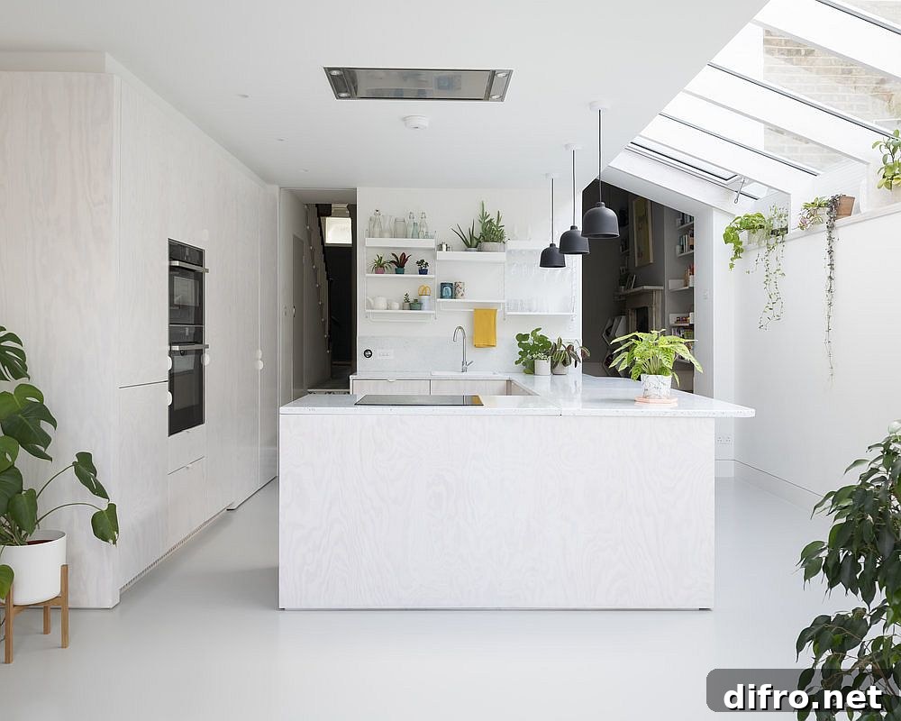 New kitchen and dining area of the British home in white acts as an interface between the old and the new
