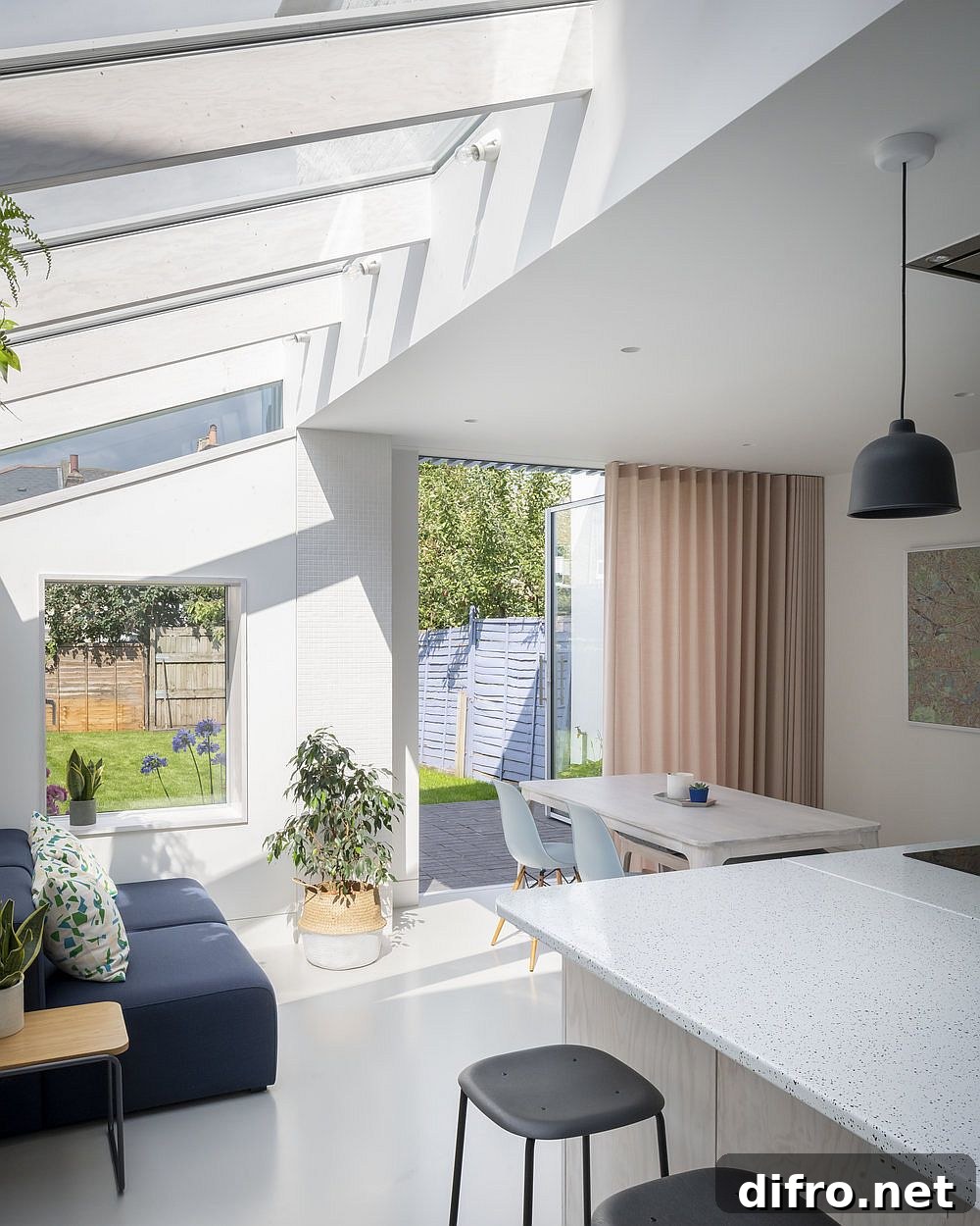 Seamless white resin floor and white walls create a spotless contemporary interior with ample natural light