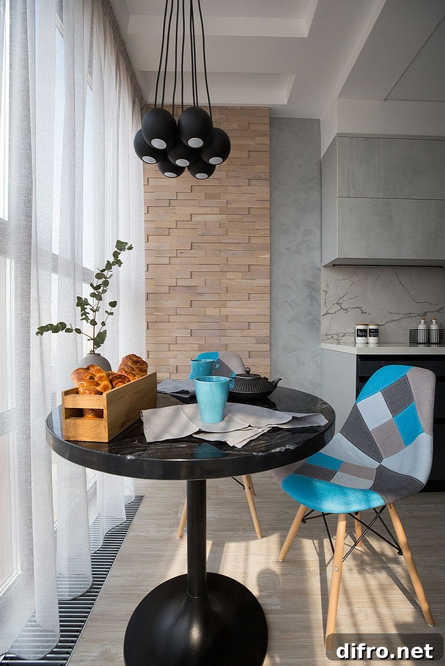 Small dark dining table with black pendants
