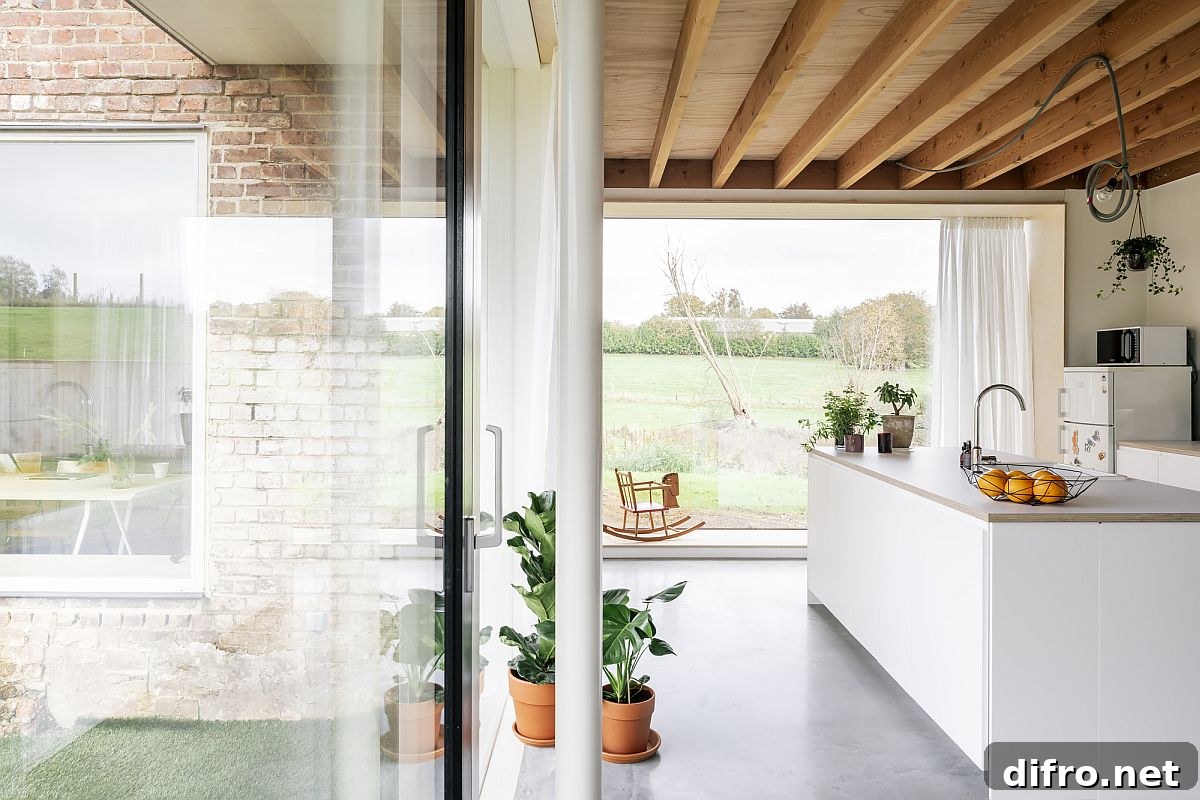Gorgeous modern white and wood kitchen with a view of the fields all around
