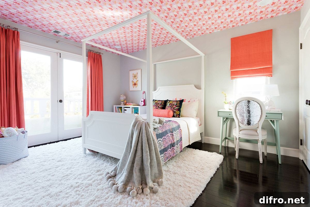 Girls' bedroom with ceiling wallpaper that accents the room's color scheme