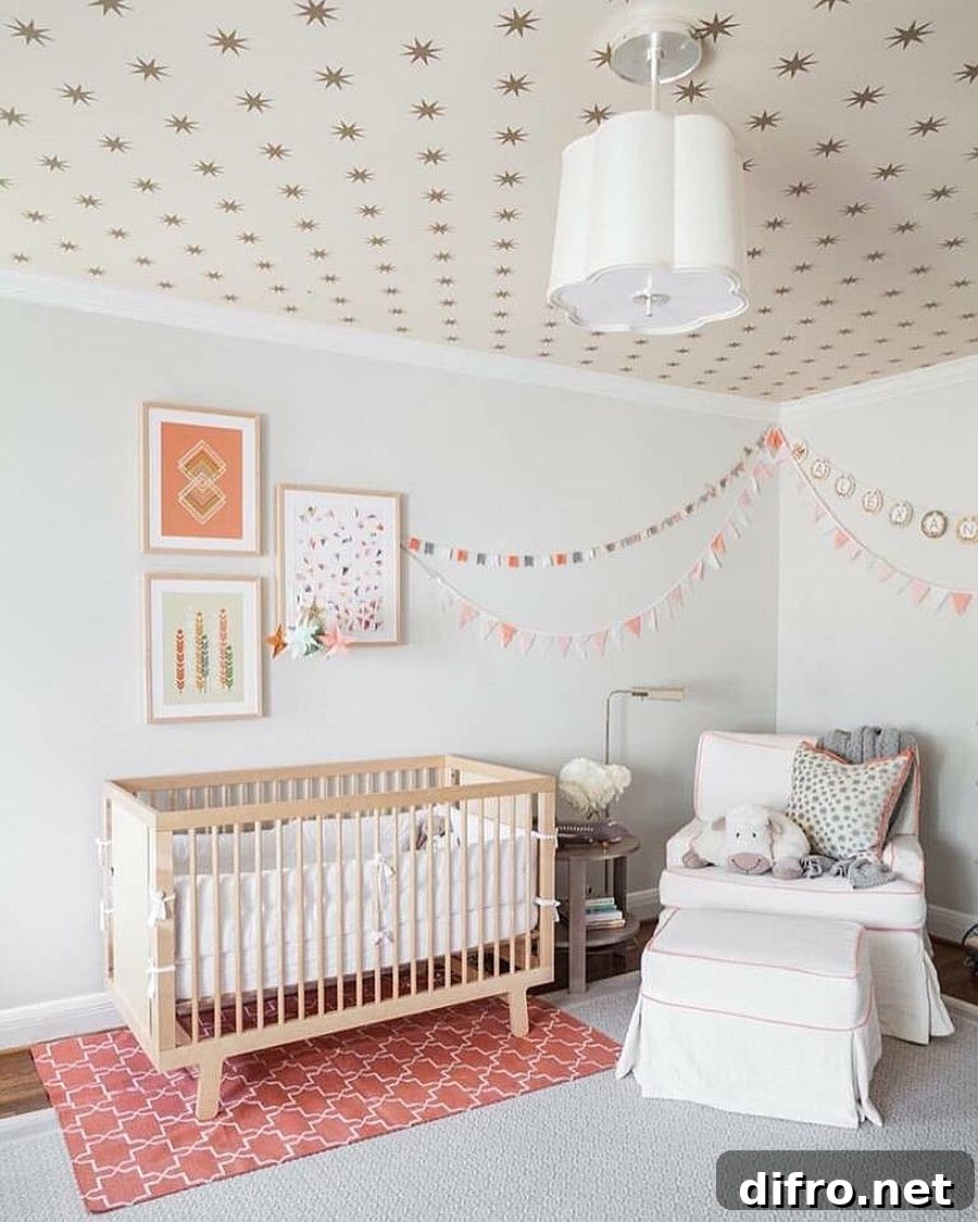 Classy nursery with white and pink tones and wallpapered ceiling