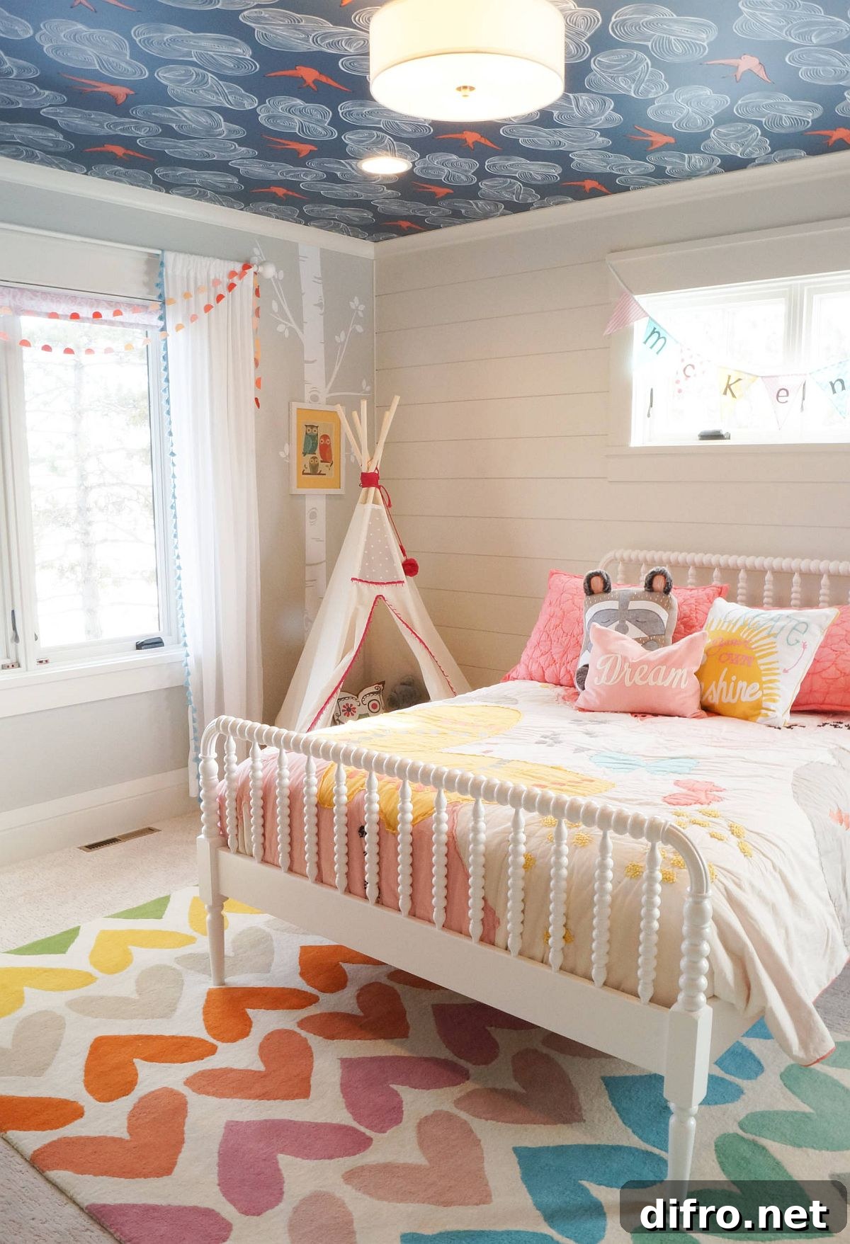 Colorful wallpapered ceiling coordinating with a kids' room rug