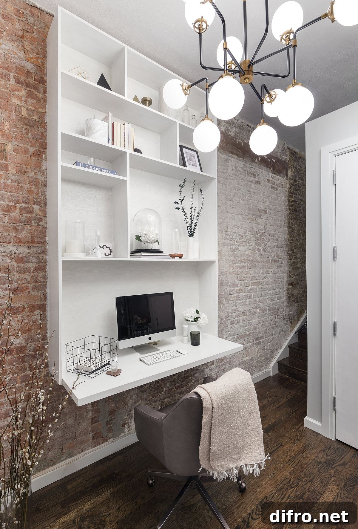 Chandelier and brick walls in hallway workspace