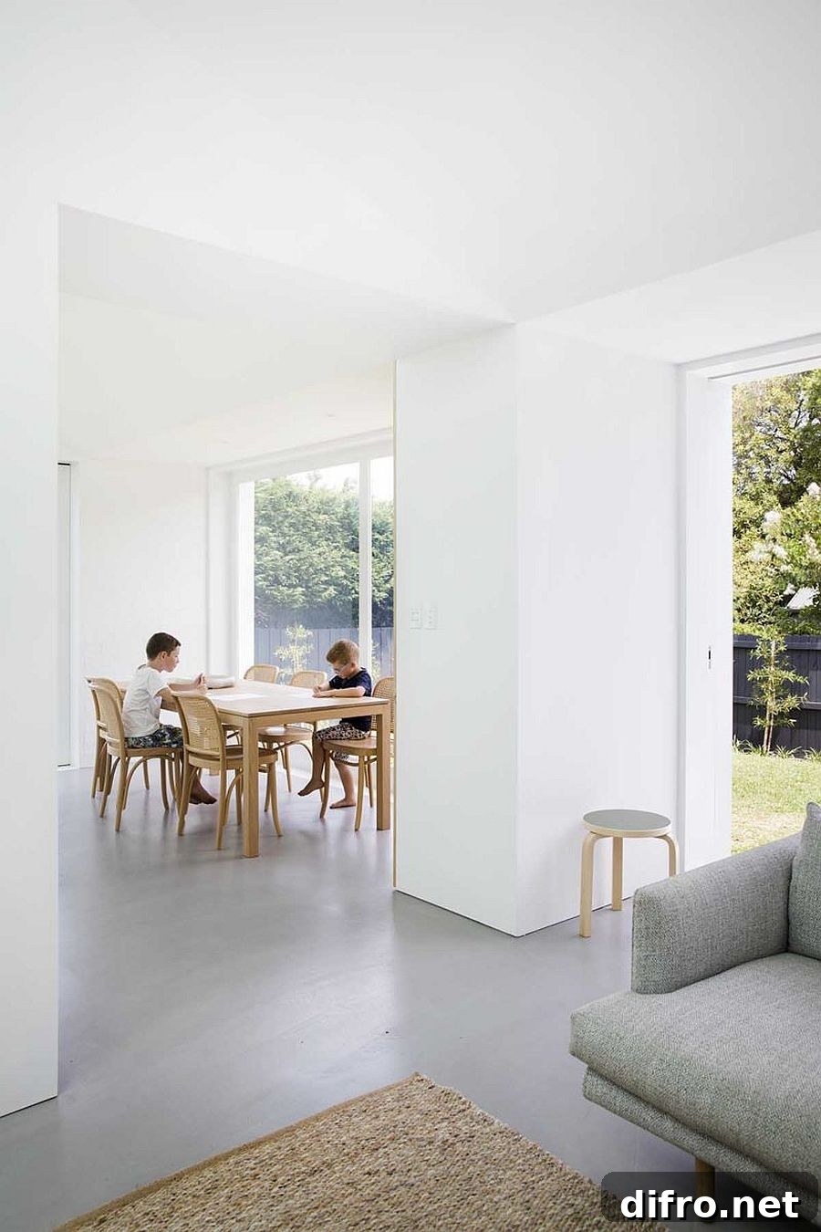 Sliding glass doors connect living area, kitchen and dining with garden