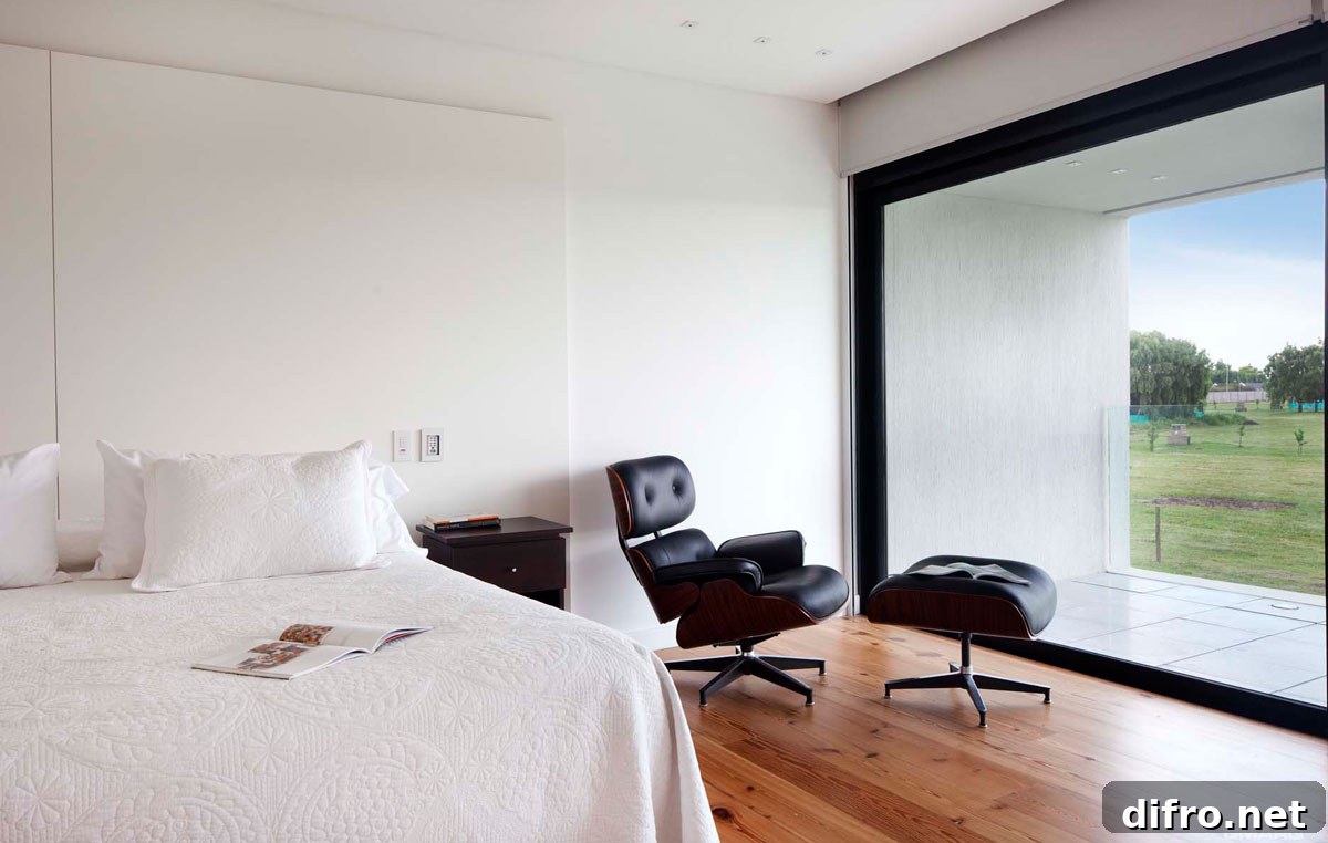 Cozy Eames Lounger in the modern bedroom with garden views