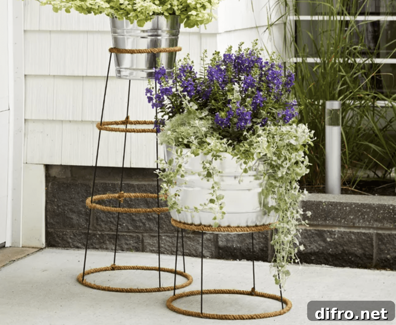 plant stand made from tomato cages wrapped in jute with planters on top