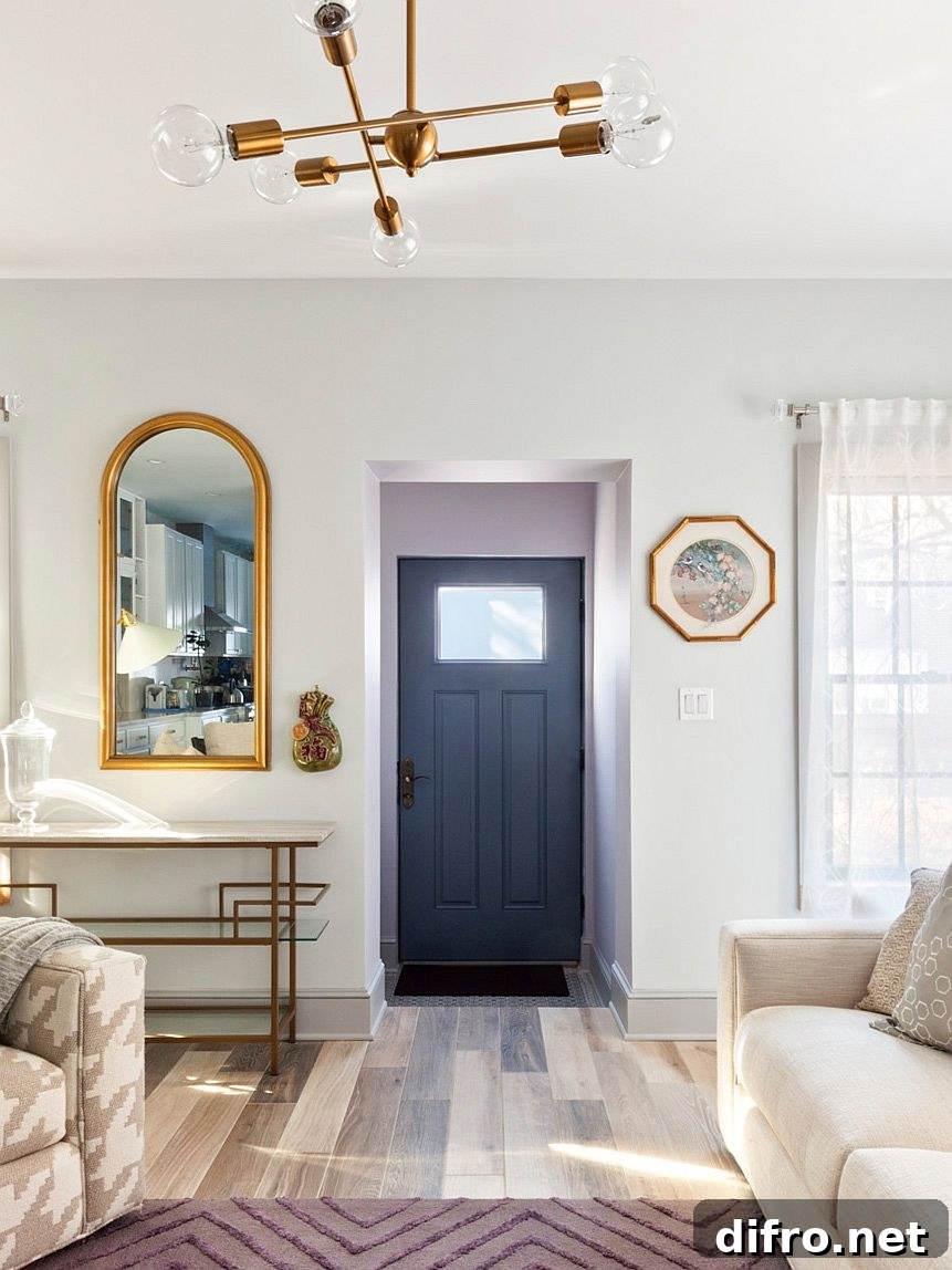 Remodeled townhouse interior with bluish-gray door and white backdrop