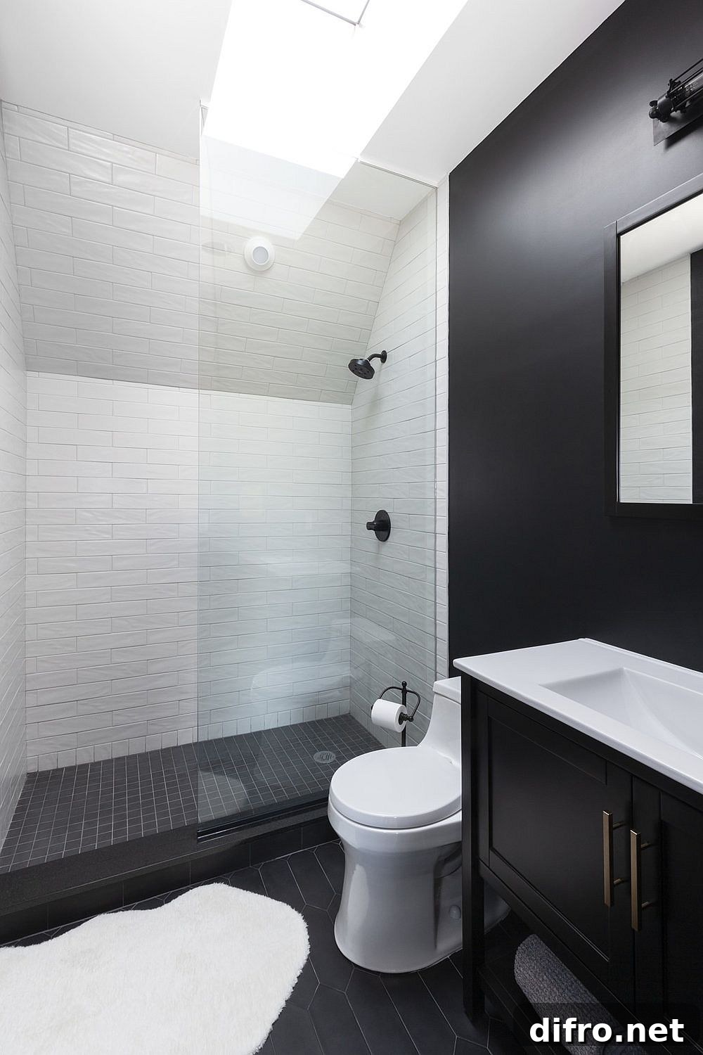 White shower area with skylight for a bright, spacious feel