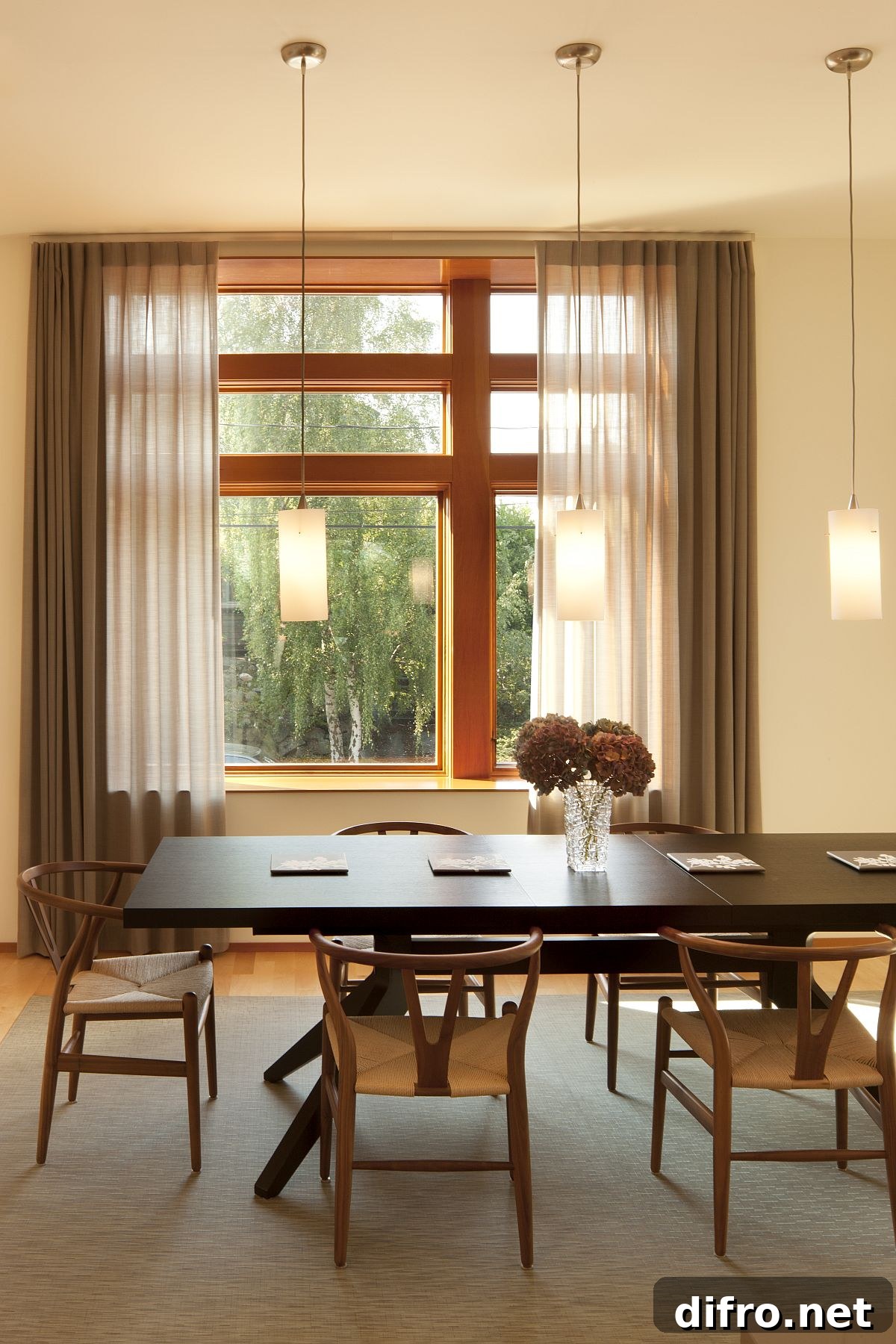 Formal dining area with drapes and pendant lights
