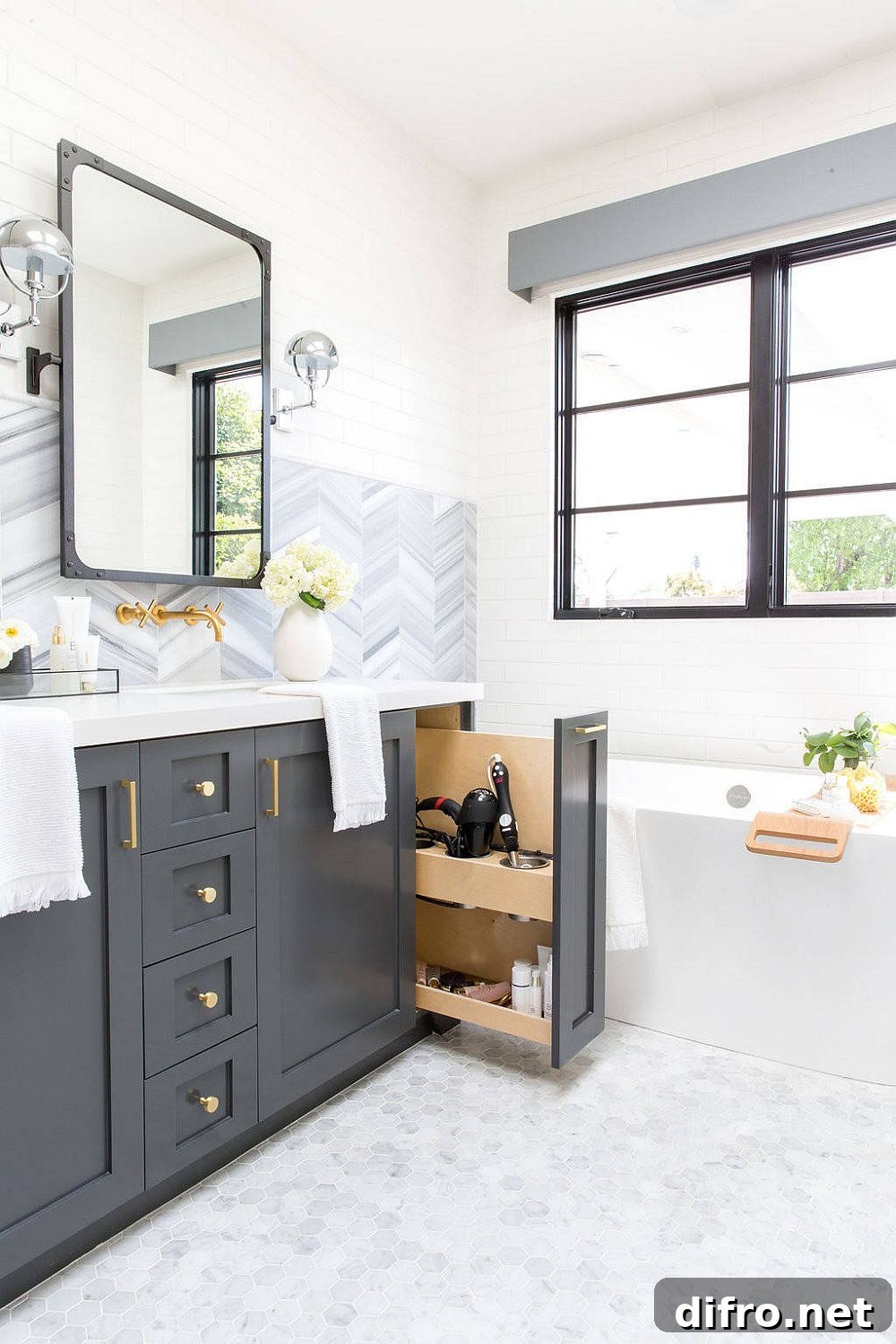 Polished white bathroom with gray cabinets and natural light