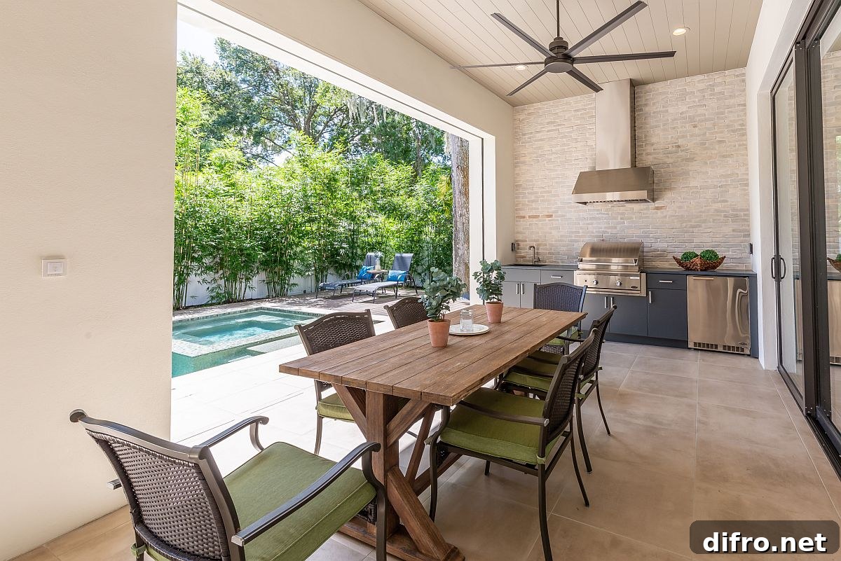 Modern Mediterranean porch with outdoor kitchen and dining area