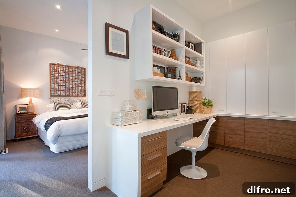 Wooden cabinets bring warmth to the home office in white next to the master bedroom [Design: Vibe Design Group / Photography by Travis De Clifford]