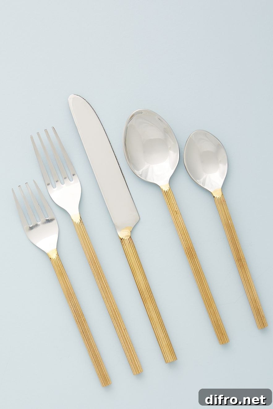 Stainless steel flatware with hand-carved gold-toned handles