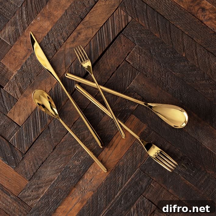 Gold flatware set with sleek long silhouettes