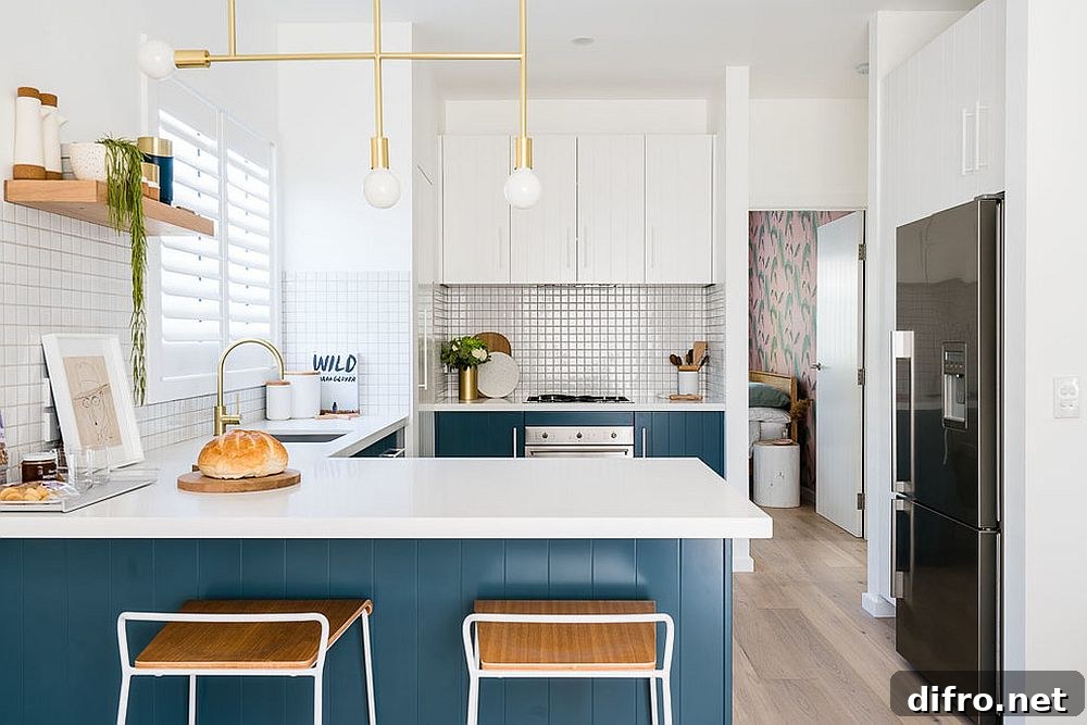 Kitchen with metallic lighting fixture, blue and white scheme