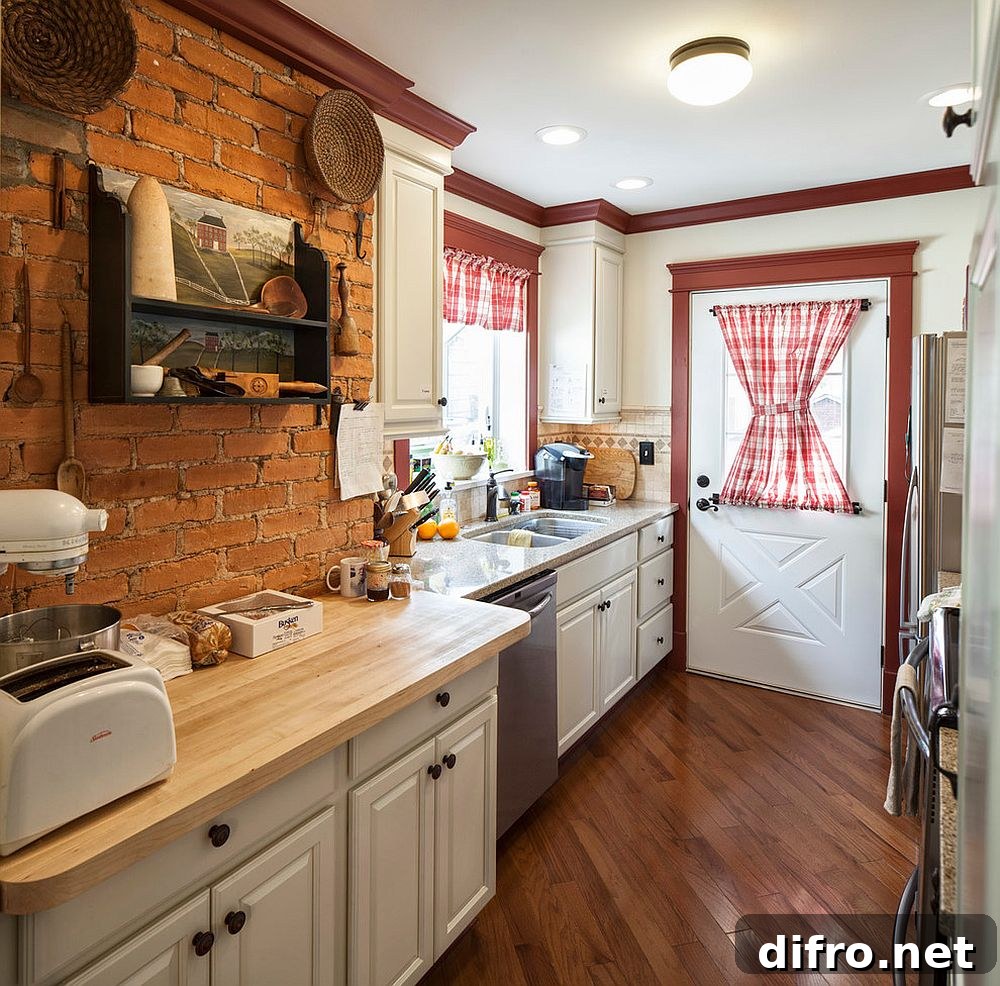 Small kitchen combining white and brick with red accents