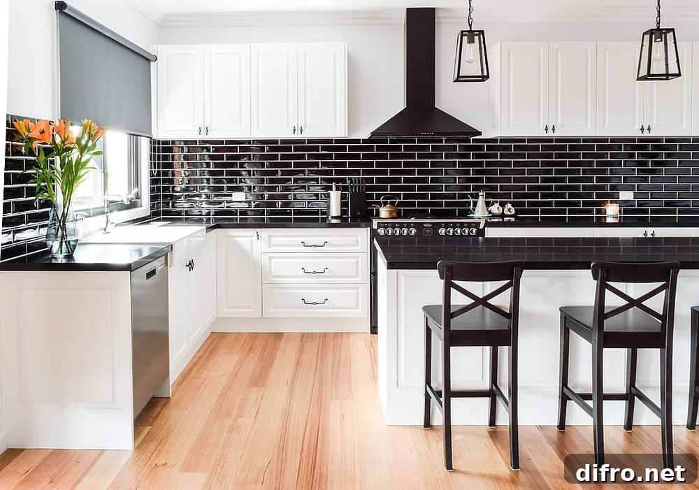 Shiny black tiled backsplash in a white kitchen