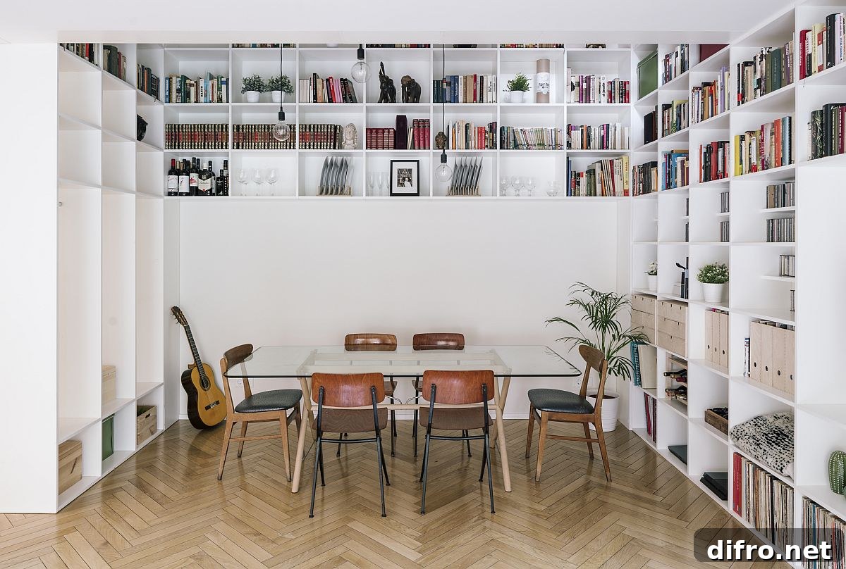 Double-height central living area of the house with bookshelves and glass table