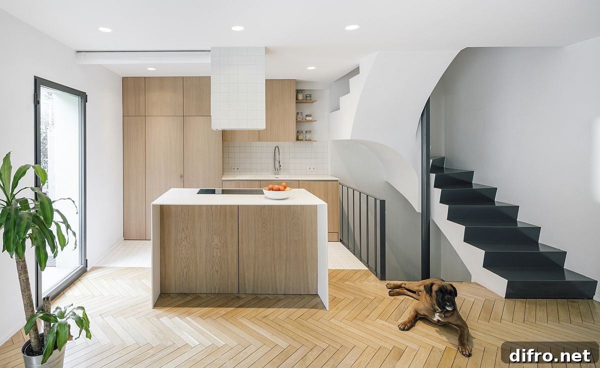 Gorgeous new kitchen of the Madrid house in white and wood with chevron pattern floor