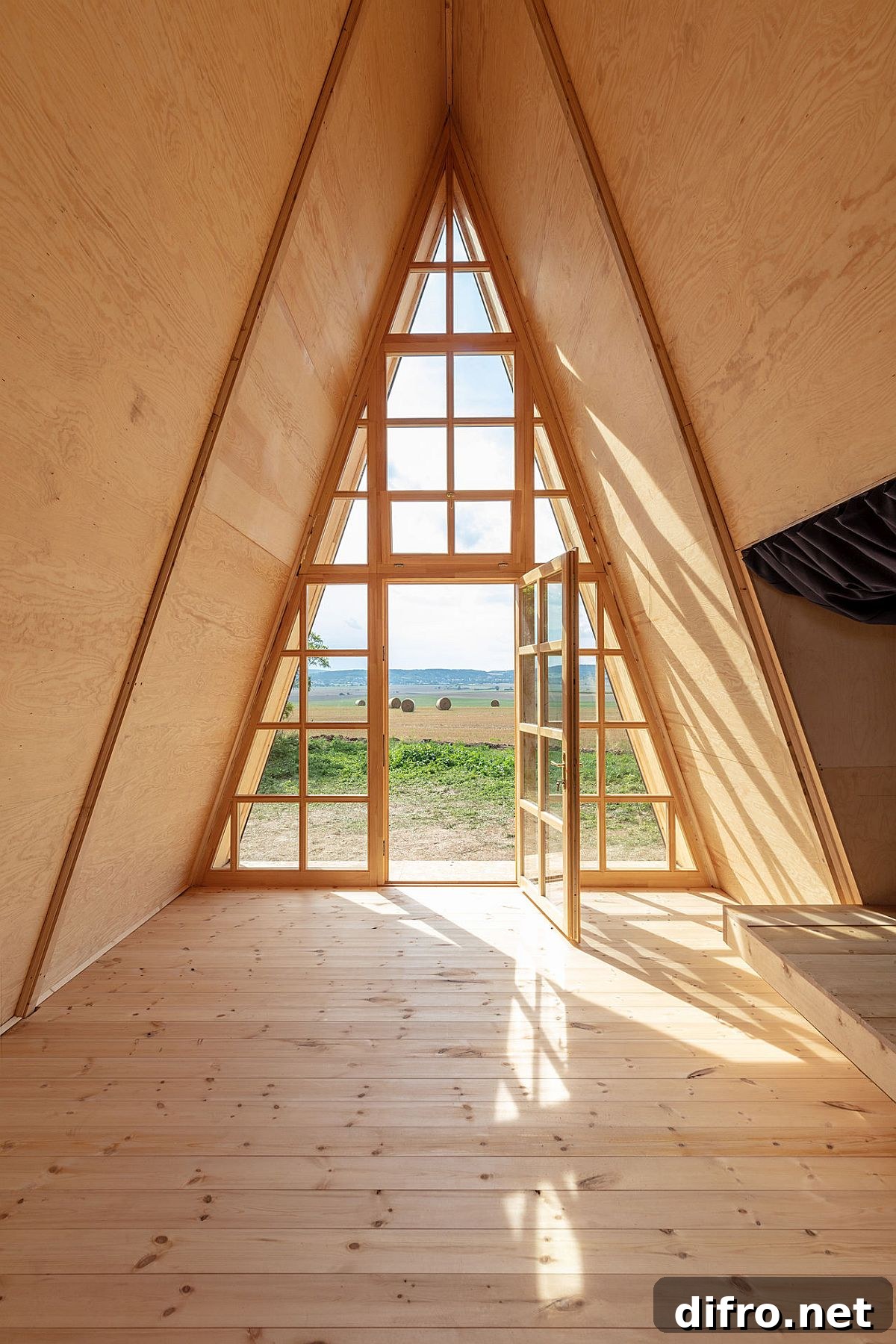 Glass walls bring light into the A-frame cabin