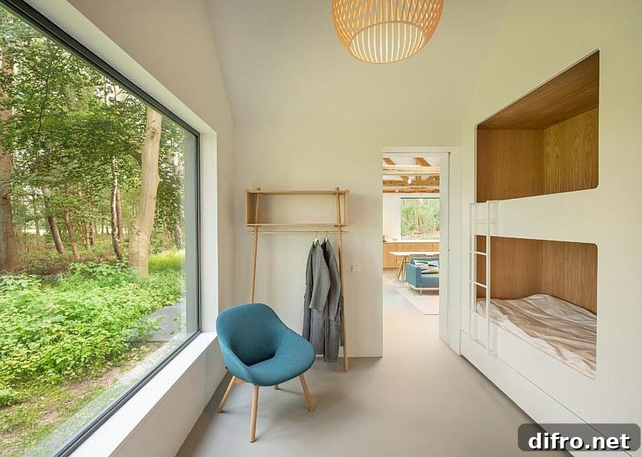 Bunk beds with a large picture window providing views of the woods