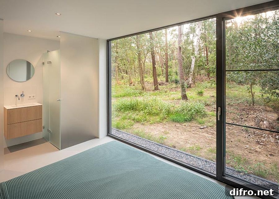 Main bedroom with sliding glass doors leading into the woods