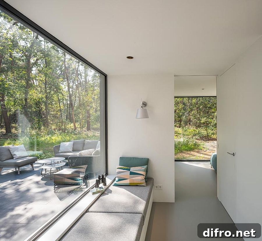Window seat beside a large window framing the green landscape