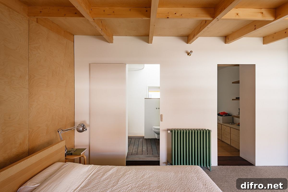 Bedroom with wooden ceiling and headboard