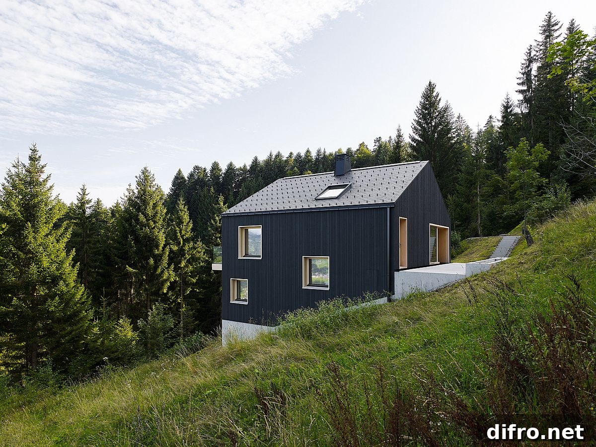 Modern home in dark wood finish on a strip foundation of an 80s home