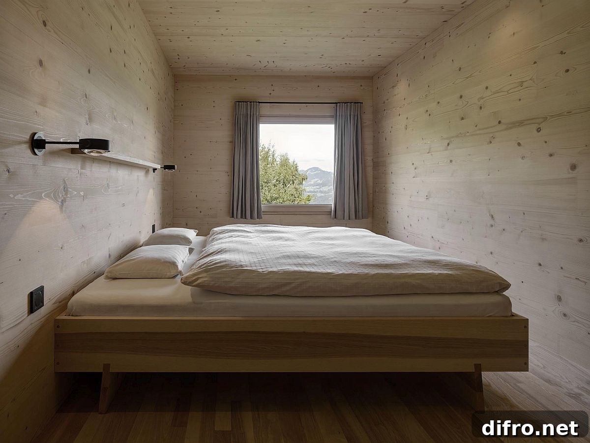 Small cozy cabin-style bedroom in wood with views of forest and distant mountains