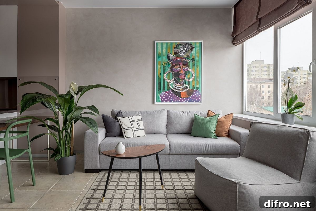 Small eclectic living room in gray with colorful accent pillows and wall art