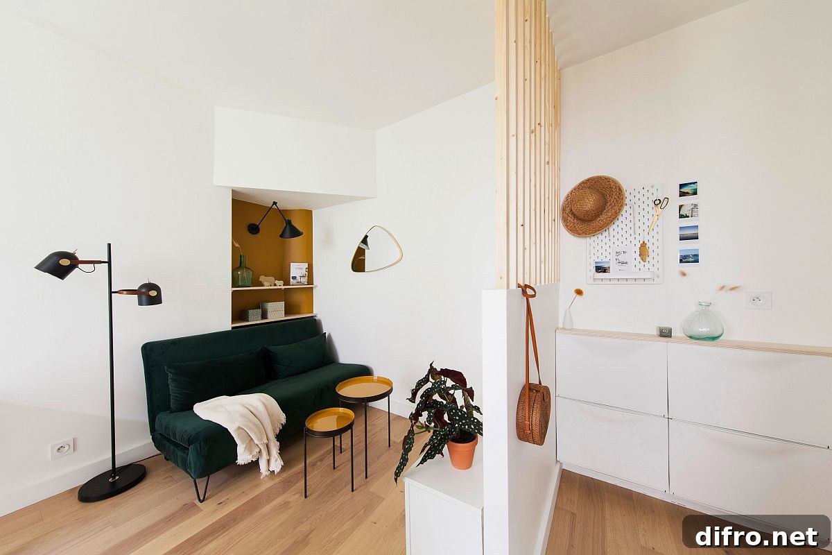 Small Scandinavian living area with dark green two-seater sofa