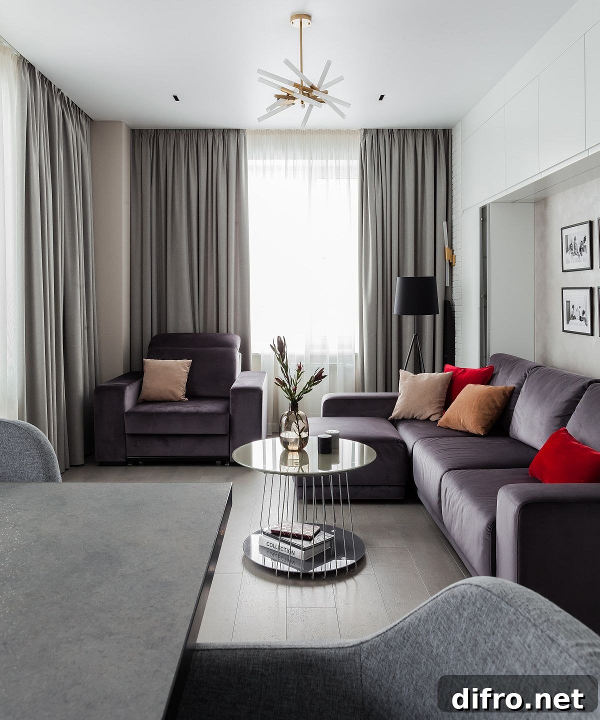 Gray sectional in a small living room with red accents
