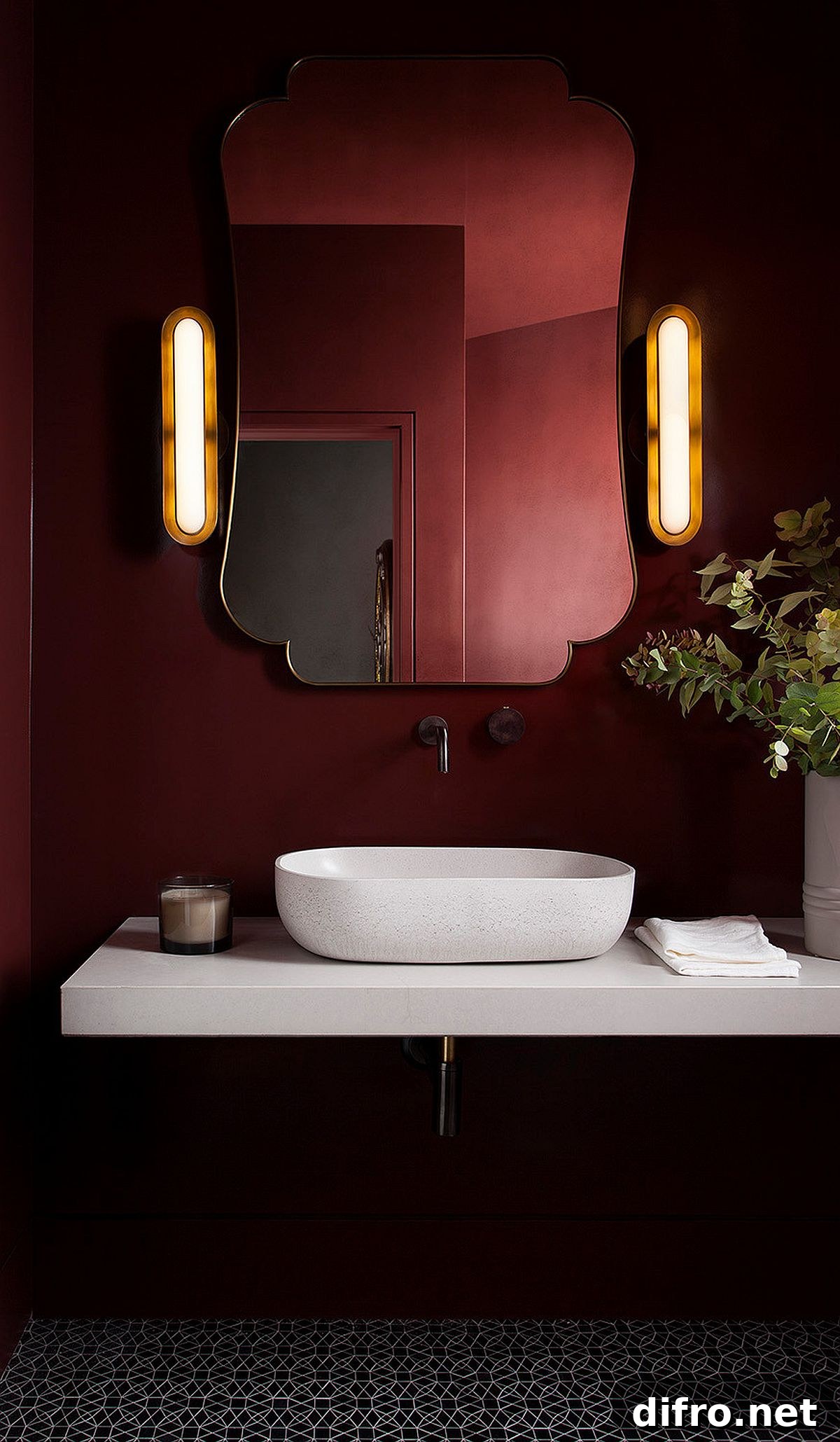 Contemporary powder room with deep red walls, mirror and sconce lights