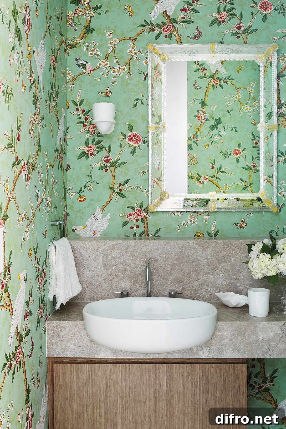 Light green nature-inspired wallpaper in a powder room