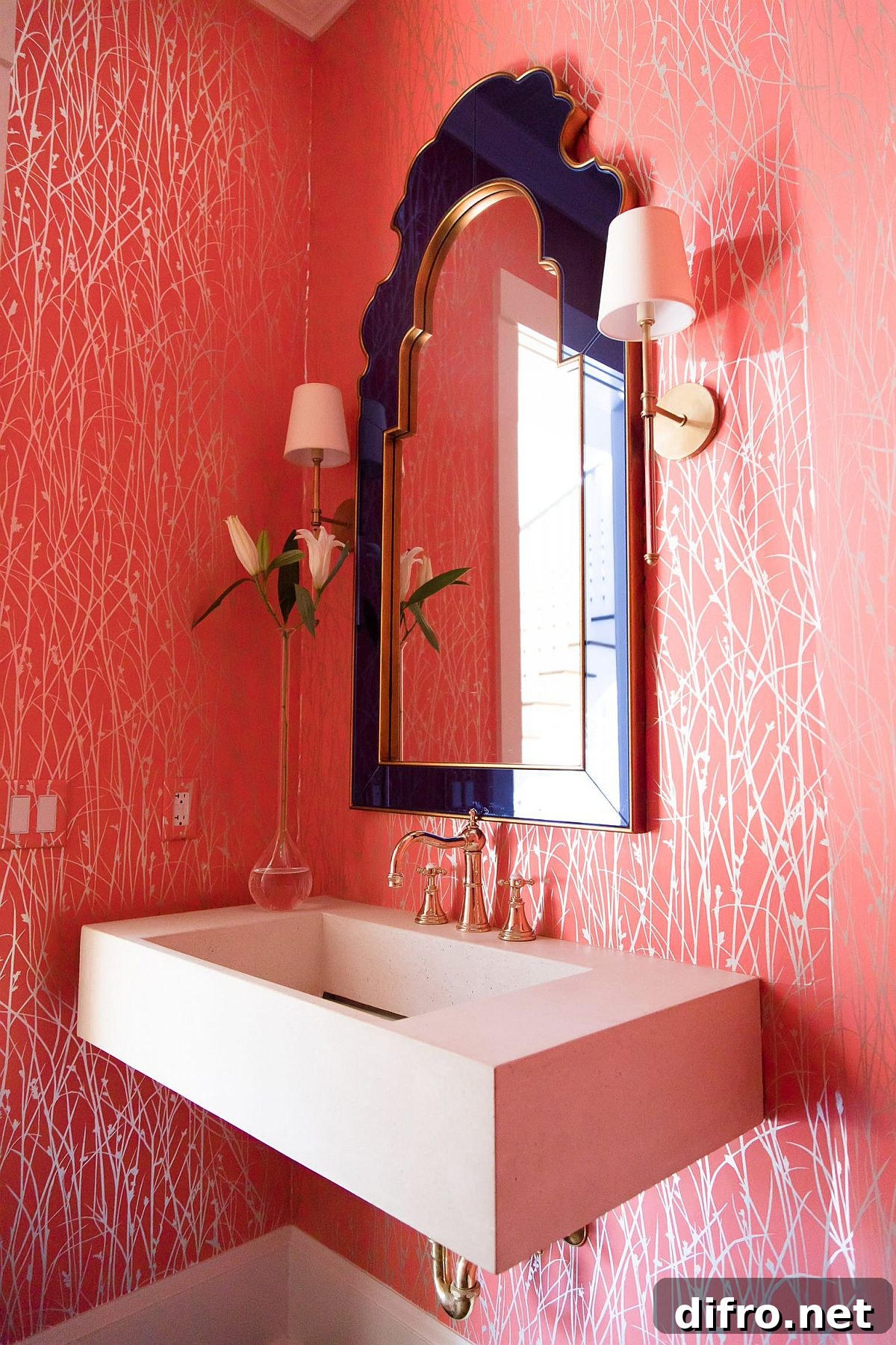 Powder room with patterned pink wallpaper and purple framed mirror