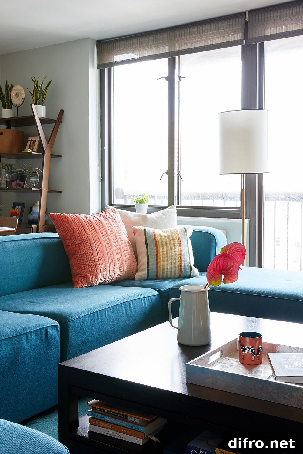 Bright accent pillows on a blue sofa