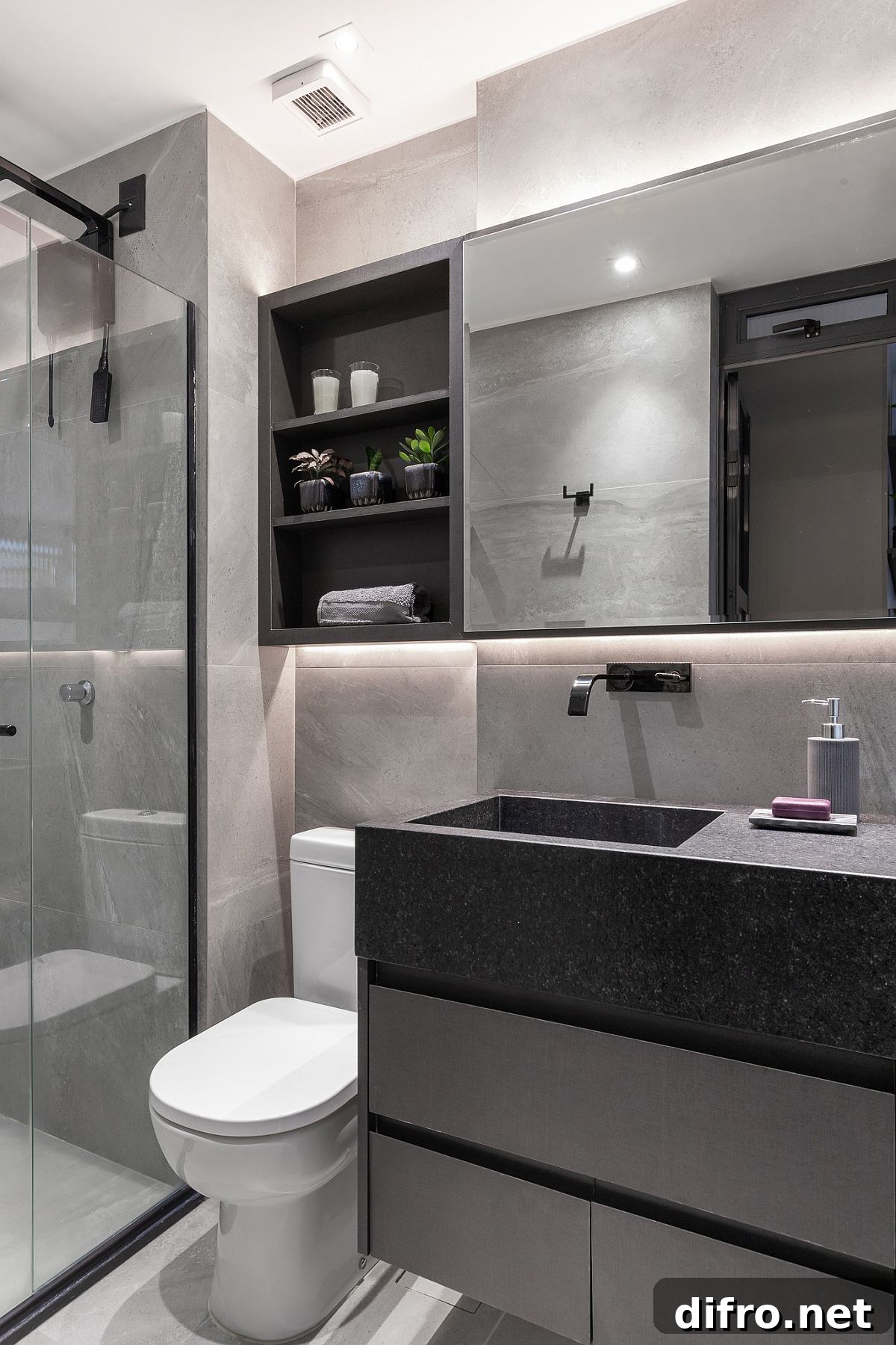 Graphite porcelain walls and carved granite countertop in the kitchen