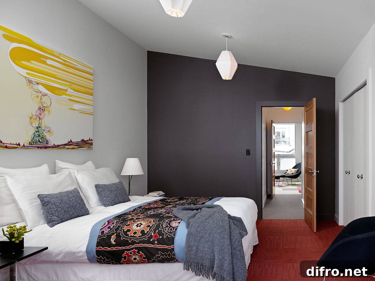 Contemporary bedroom with dark gray accent wall