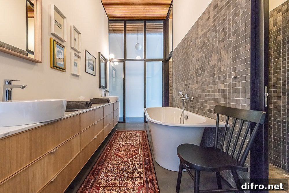 Bathroom open at both ends connects to the bedroom with sliding glass doors