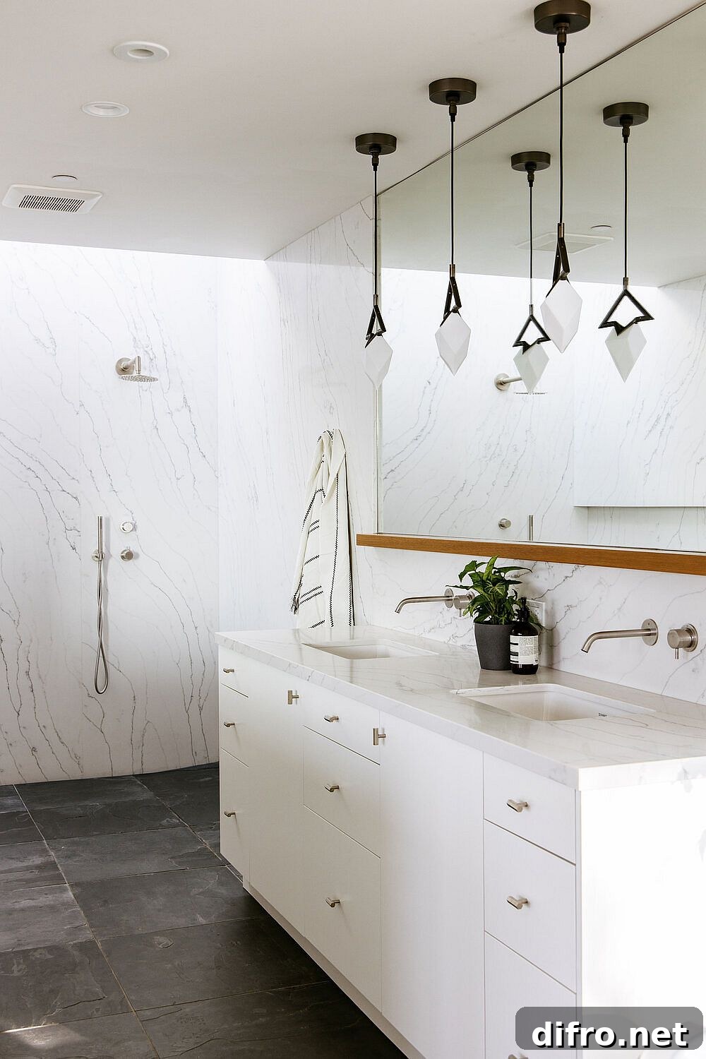 Marble countertops and dark stone flooring in the bathroom