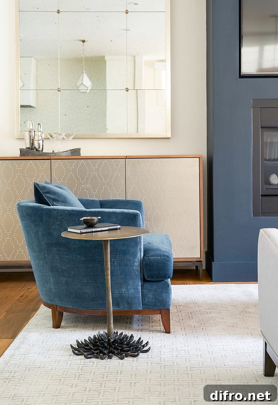 Blue club chair and metallic side table next to the home bar