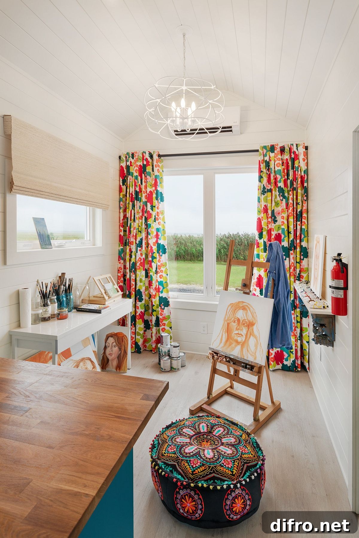 Small home office with pattern-filled drapes and ottoman