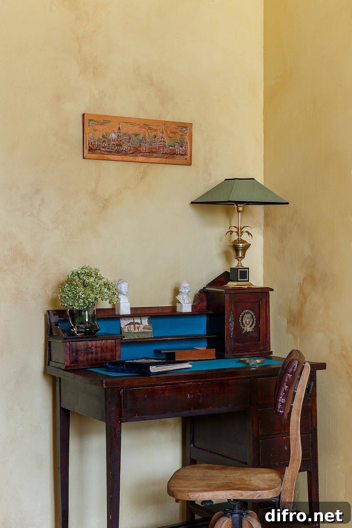 Corner eclectic home workspace with a small freestanding desk and textured walls