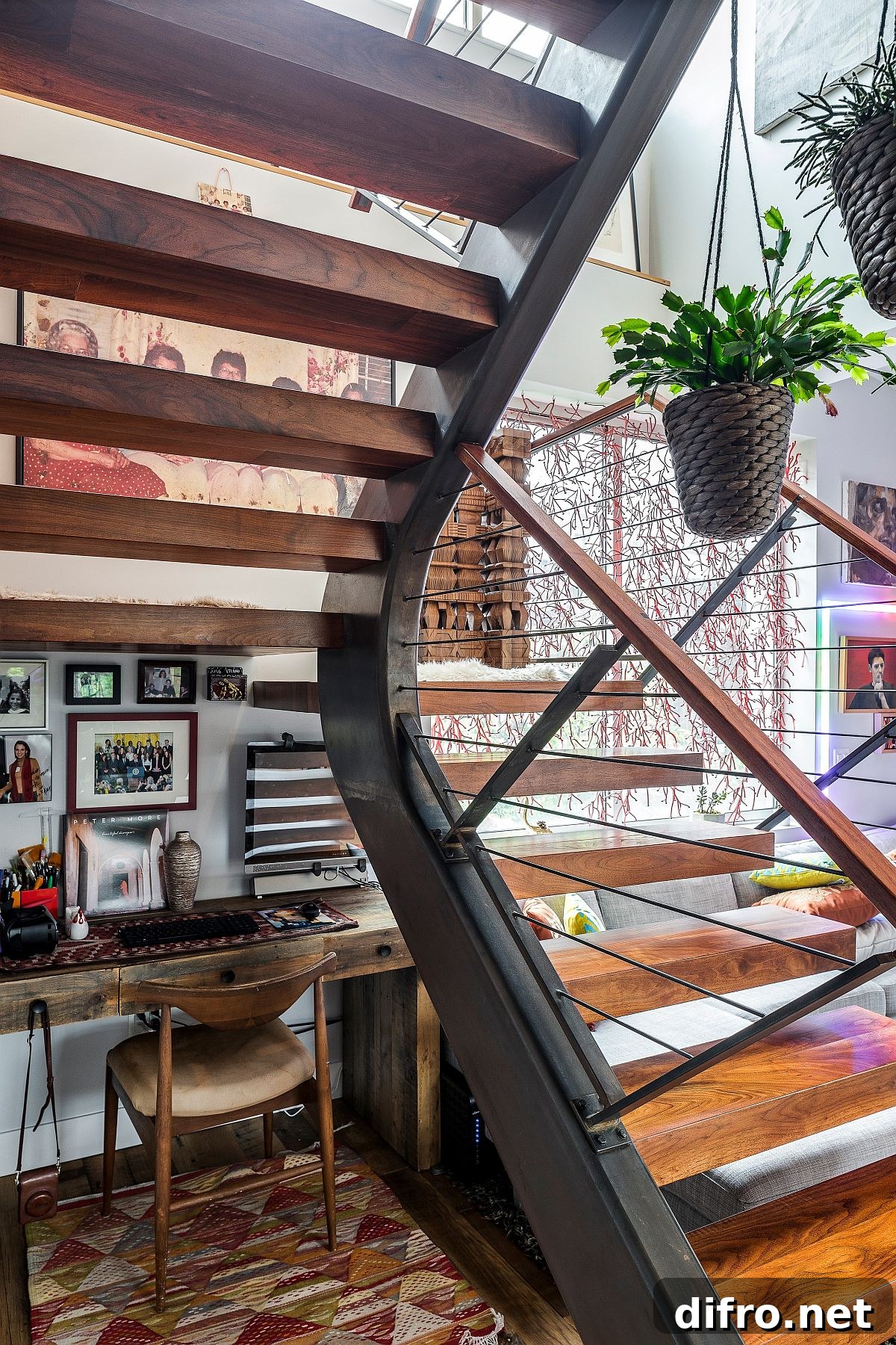 Small workspace under the staircase with a simple wooden desk