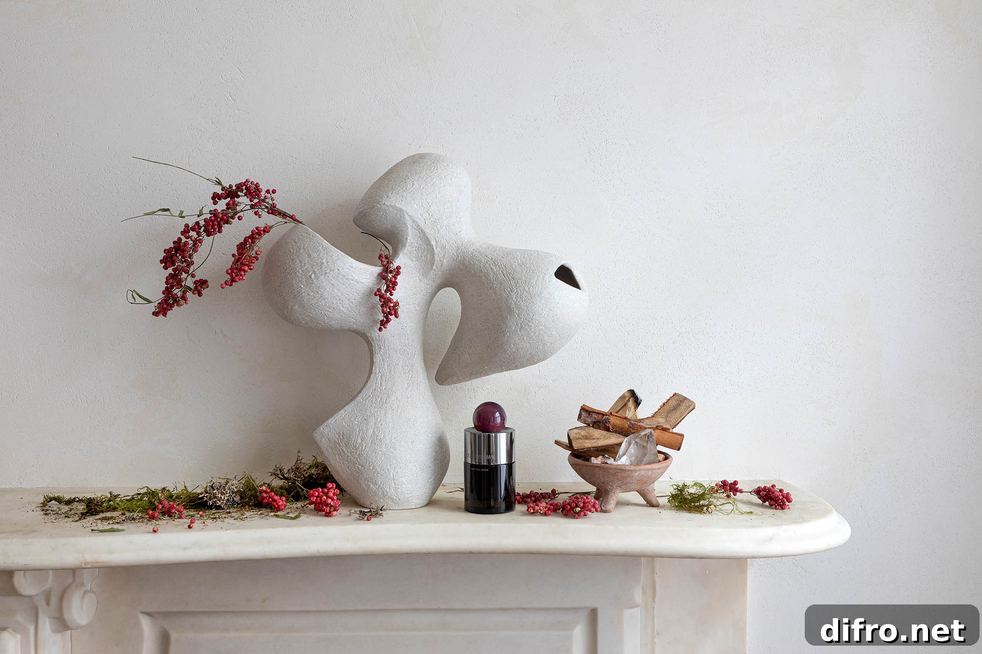 White sculptural form on a fireplace mantel