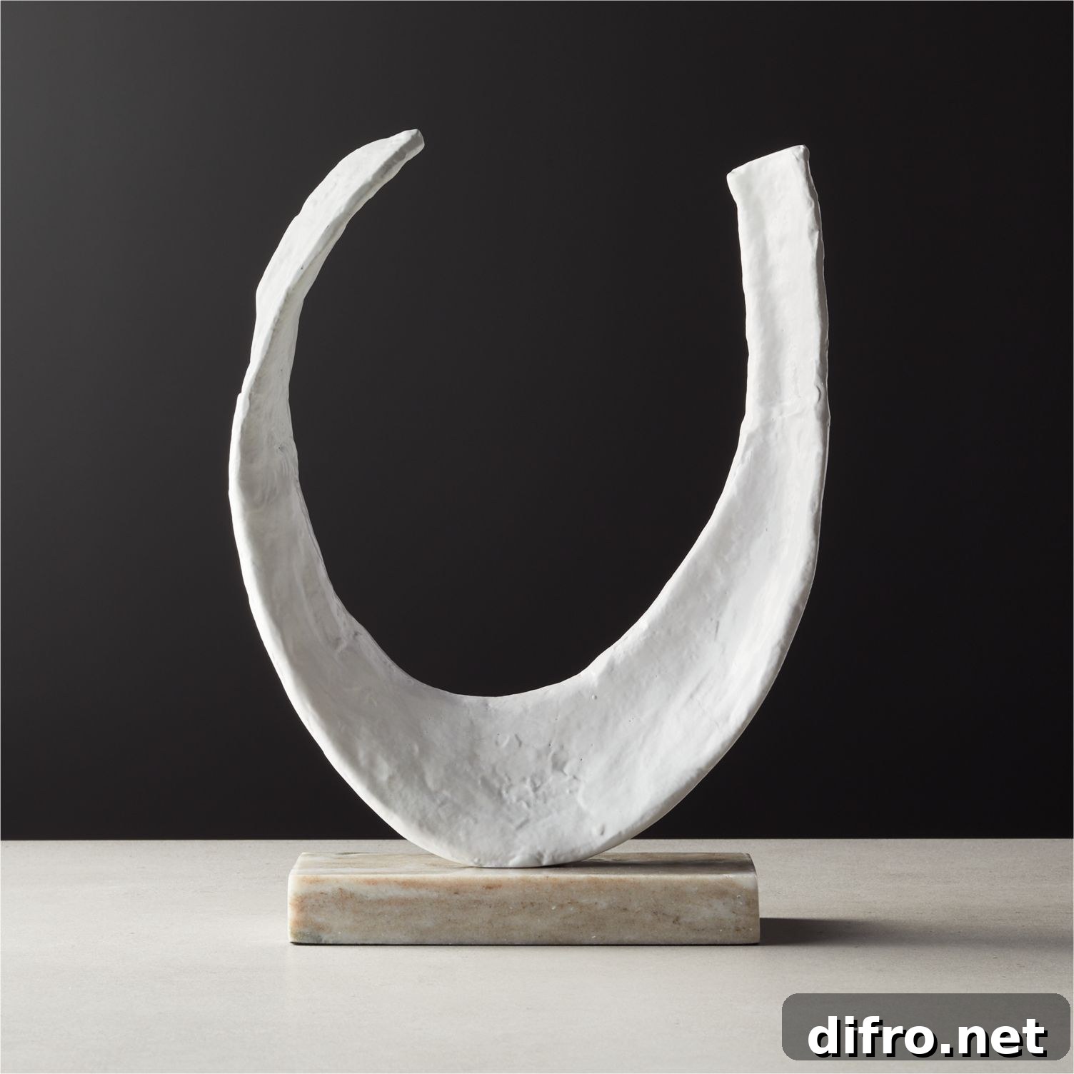 Textured aluminum sculpture on a table