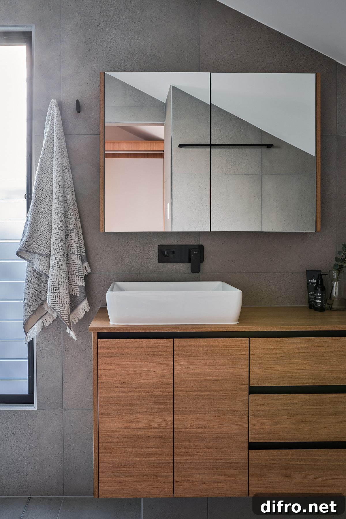 Bathroom with gray tiles and floating wooden vanity